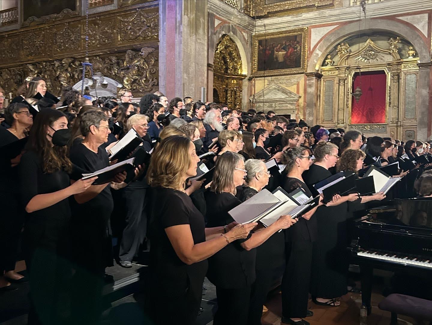 A group of people singing in a church

AI-generated content may be incorrect.